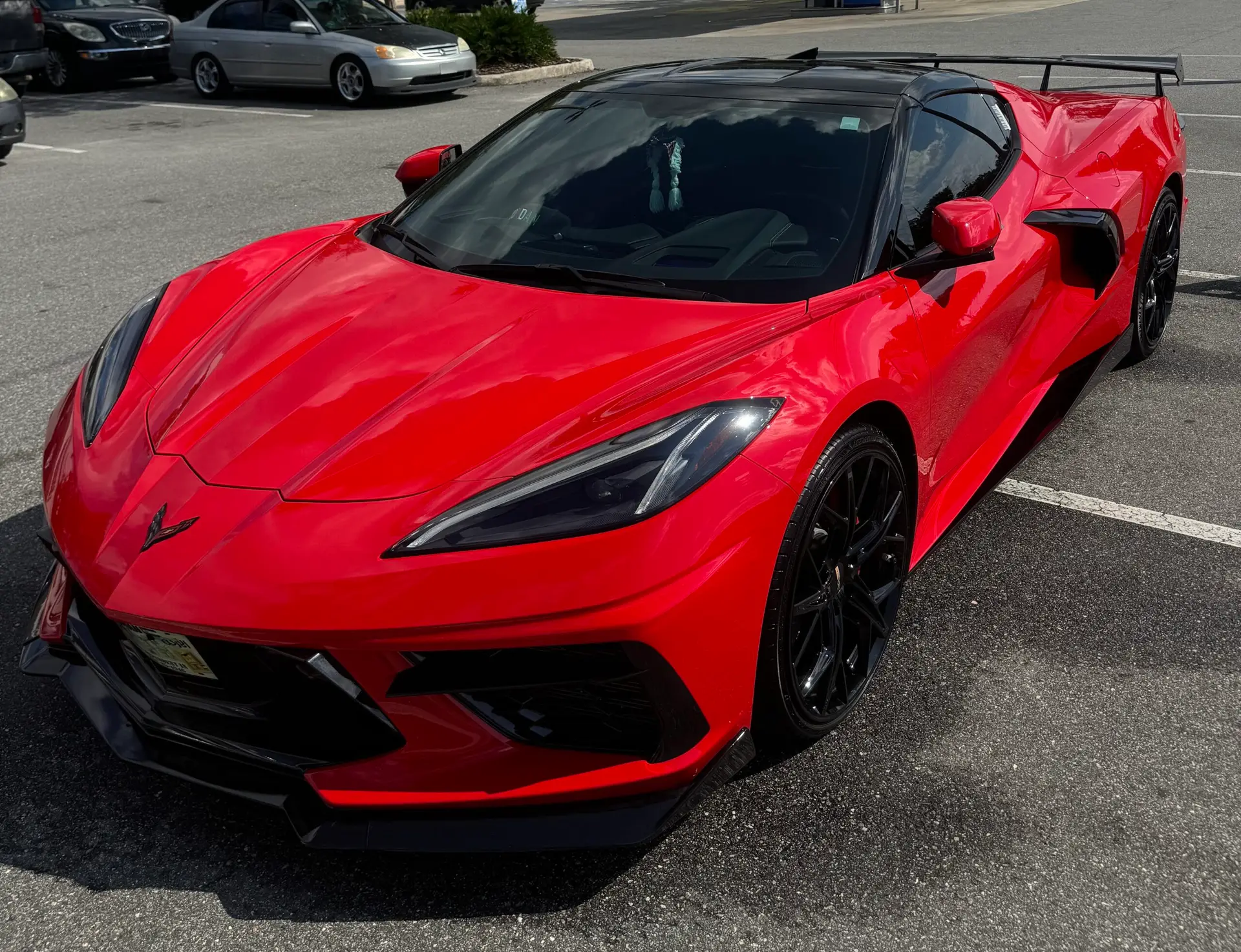 Professional ceramic coating applied to red sport car, enhancing shine and paint protection, offered by Phantom Mobile Detailing in Jacksonville, FL